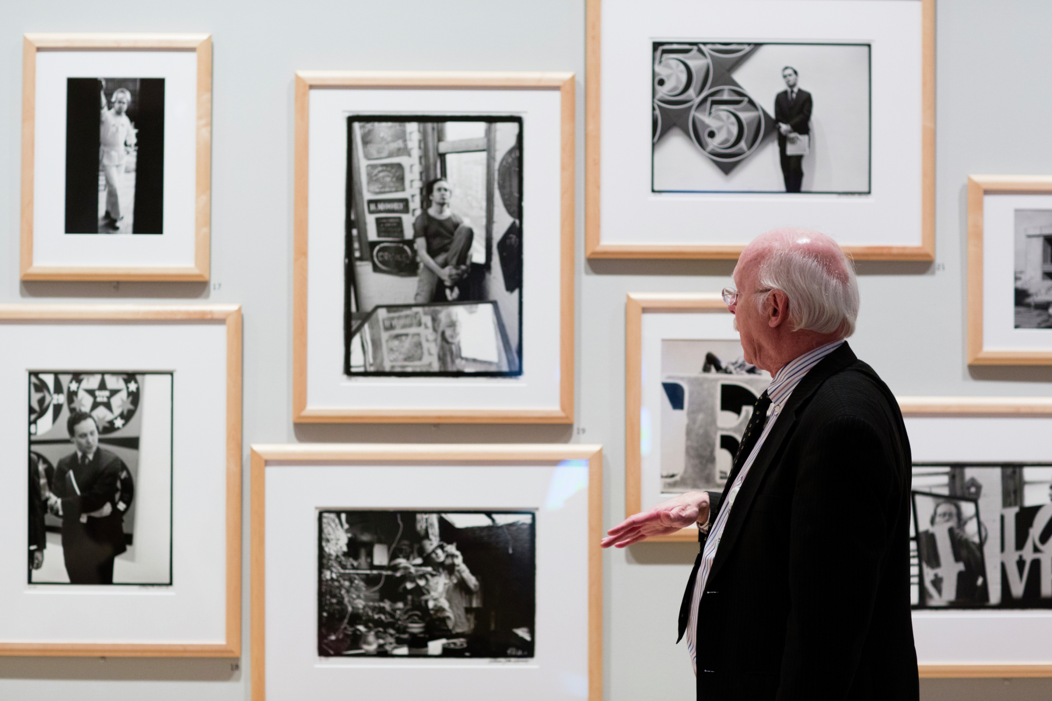 Man looking at artoworks in a museum setting.