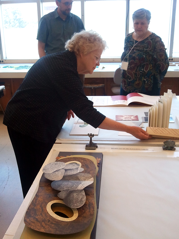 Woman looking closely at books.