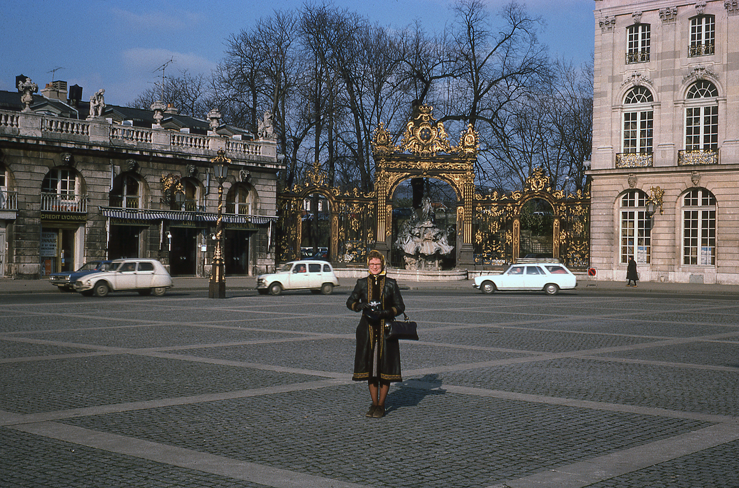 Woman standing outside in an open space.