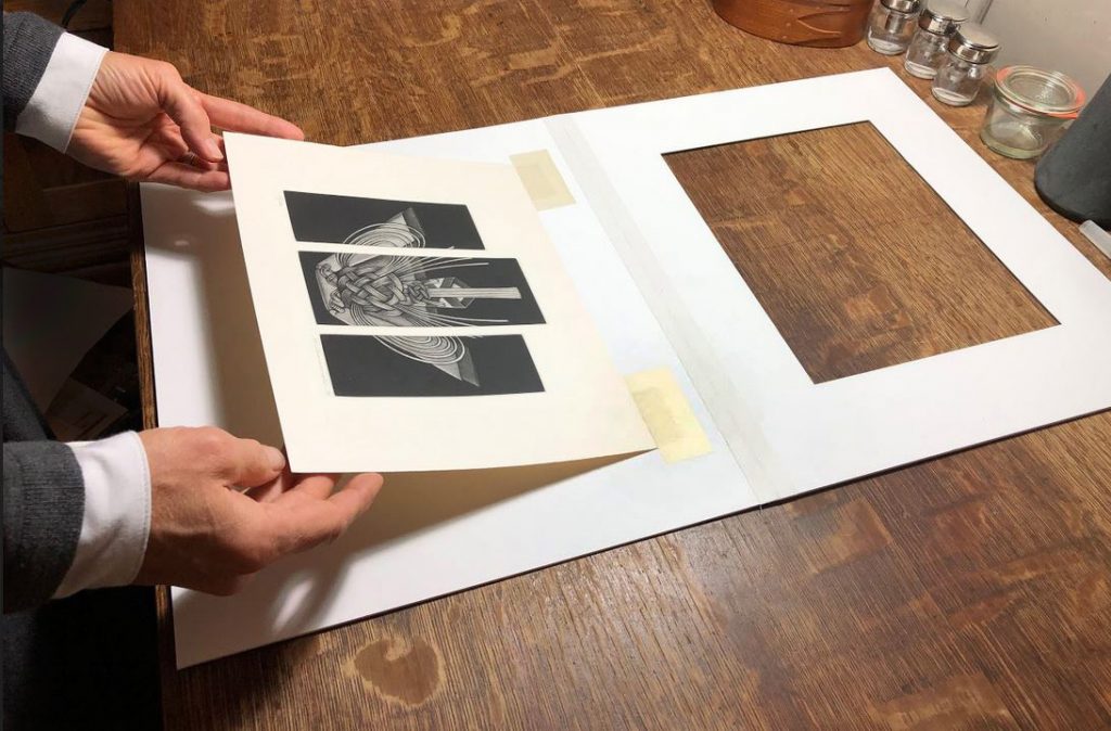 Image illustrating a print being matted.